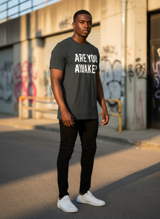 Man wearing a t-shirt with 'ARE YOU AWAKE?' text in an urban setting